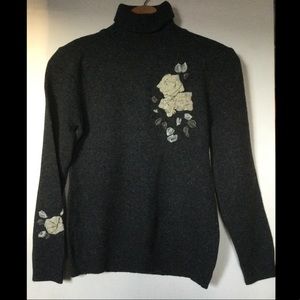 Black knit turtleneck with floral detailing